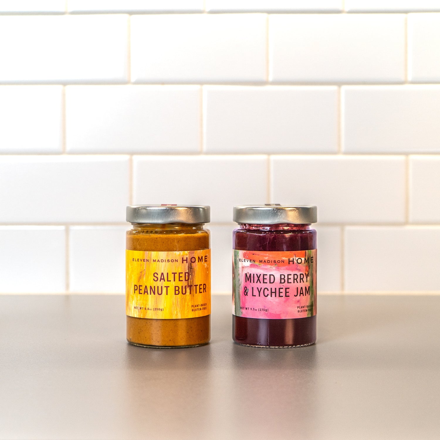 A jar of salted peanut butter and mixed berry & lychee jam