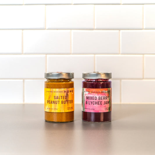 A jar of salted peanut butter and mixed berry & lychee jam